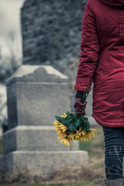 Closeup of a Sad in front of a Gravestone
