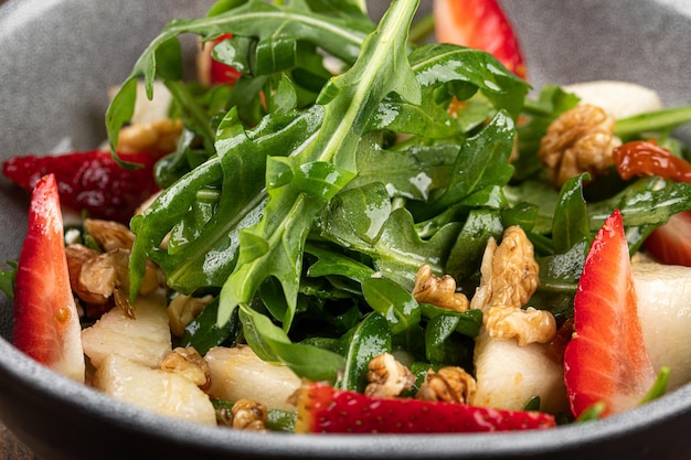 Closeup on salad with arugula and strawberries