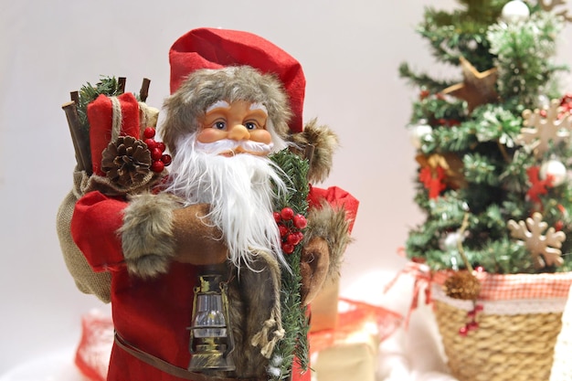 Closeup of santa claus doll santa claus statue with christmas decorations and gifts