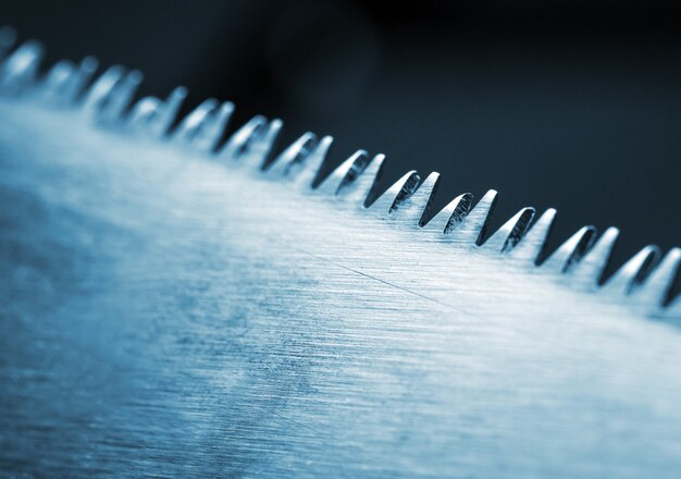 Closeup of saw blade. Toned in blue