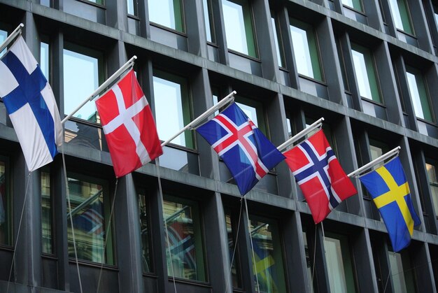 Closeup of Scandinavian flags hanging from building