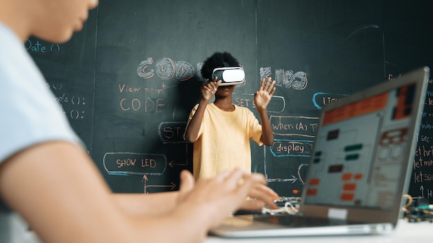 Closeup of school girl hand coding program while student using VR Edification