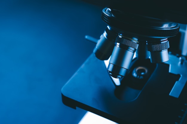 Closeup of scientific microscope with metal lens