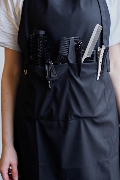 Closeup of scissors and combs in a holster box Hairdressing tools inside a hairdresser's waist bag