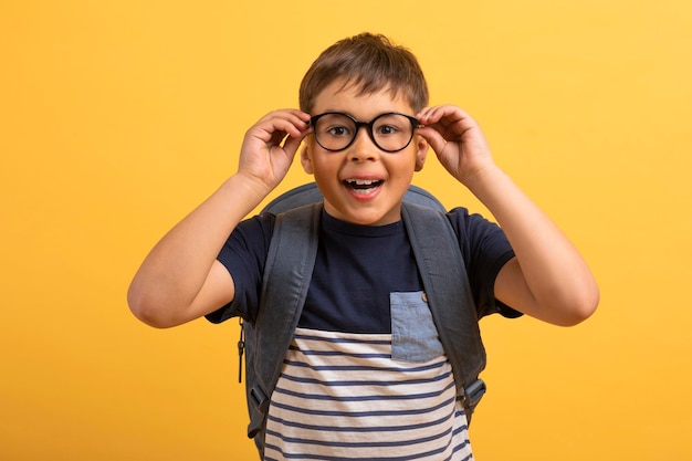 Closeup of scooler boy adjusting eyewear and looking at camera