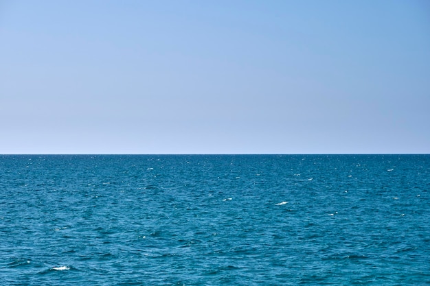 Closeup seascape surface of blue sea water with small ripple waves