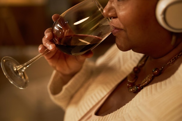 Closeup of senior black woman drinking wine