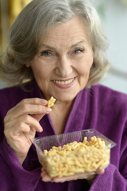 Closeup of a senior woman with cookies