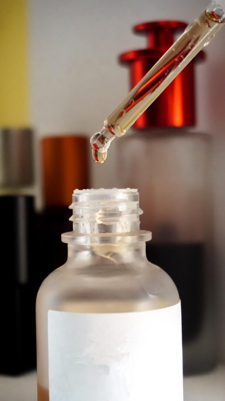 Photo closeup of a serum dropper on a bottle in a bathroom shelf