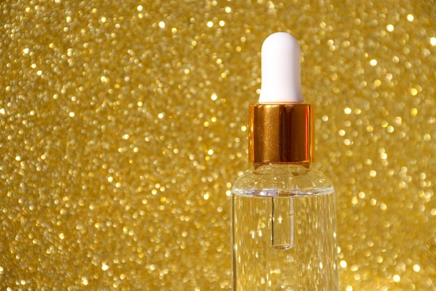 Closeup of serum in glass bottles on a gold background Cosmetics and care