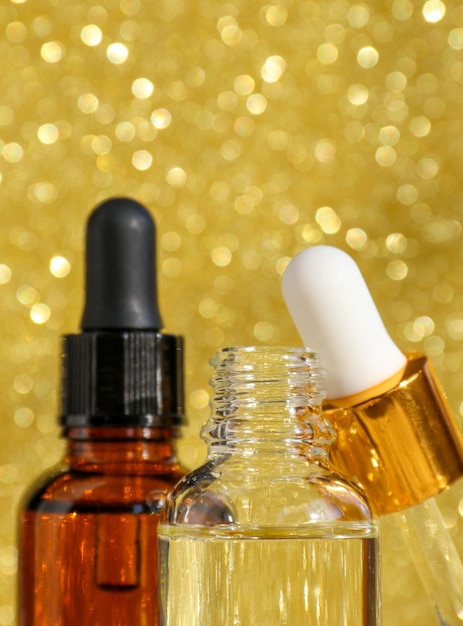Closeup of serum in glass bottles on a gold background Cosmetics and care