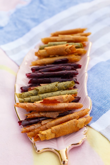 Closeup set of colorful pastillum rolls on tray.