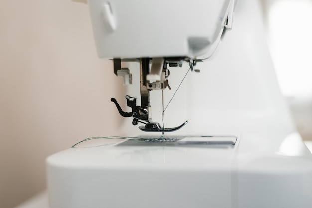 Closeup of a sewing machine with a needle and thread