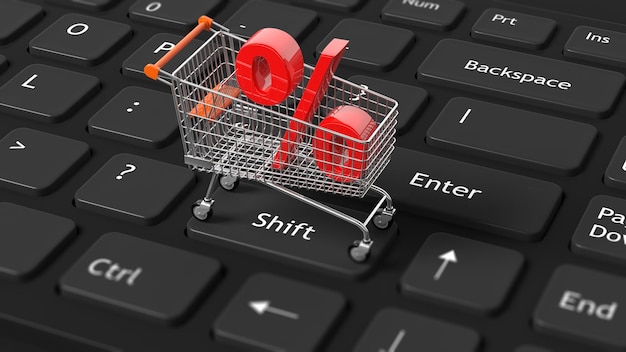 Closeup of shopping cart with red percent symbol on keyboard