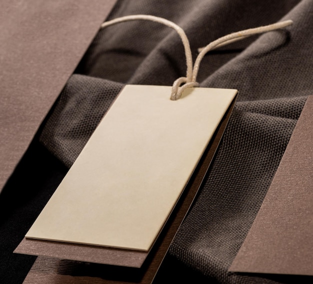 A closeup shot of a blank clothing tag on a string for a price label on a cloth