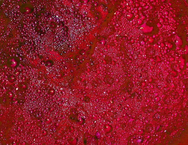 Closeup shot of bloody bubbles or a puddle of blood red liquid can be used as background