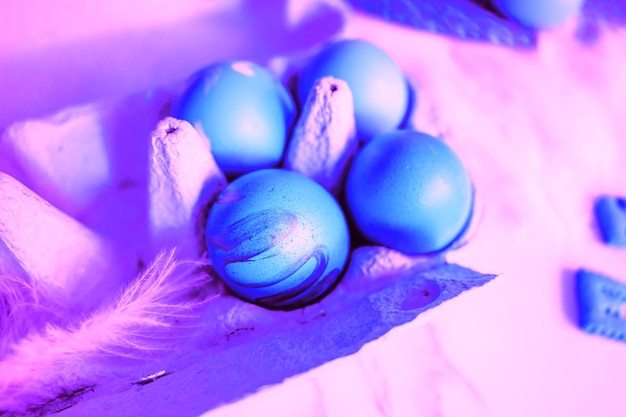 Closeup shot of blue chicken eggs abstract purple background. Rustic composition with Easter atmosphere. Concept of farm products, natural food, Easter holiday, top view