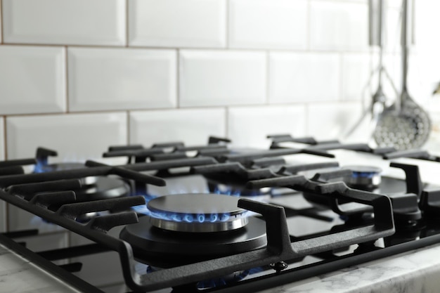 Closeup shot of blue fire from domestic kitchen stove top. Gas cooker with burning flames of propane gas. Industrial resources and economy concept.