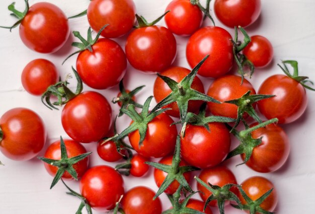 Closeup shot of a bunch of cherry tomatoes isolated on a white background
