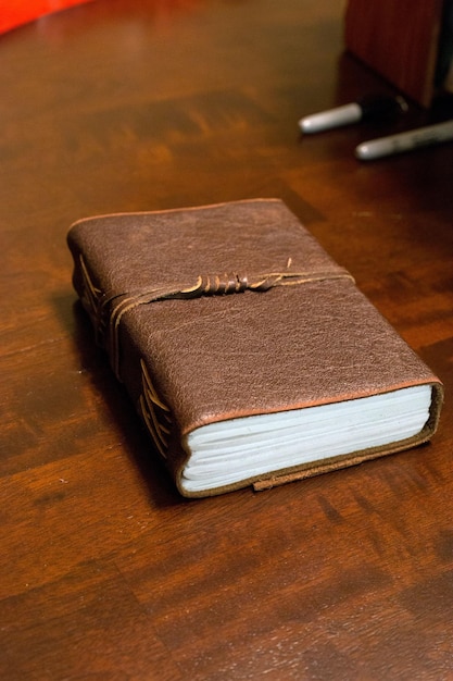 Closeup shot of a closed notebook on the wooden table