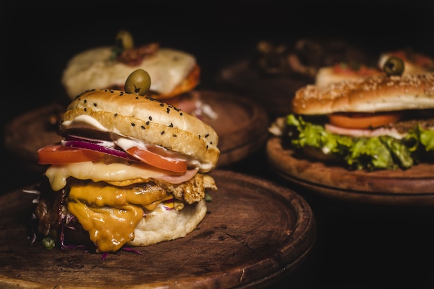 Closeup shot of delicious burgers on a wooden tray