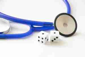 Photo closeup shot of dice and stethoscope