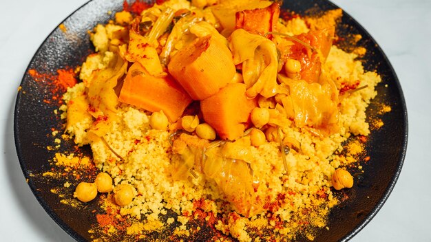 Closeup shot of a dish with the mixture of crisp chickpeas carrot cabbage and seasonings