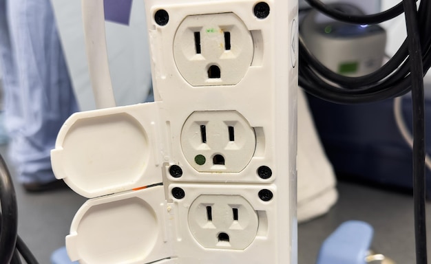 Closeup shot of an electric plug outlet installed in a white wall