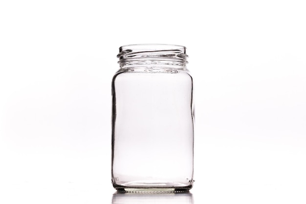 Photo closeup shot of an empty glass jar isolated on a white background