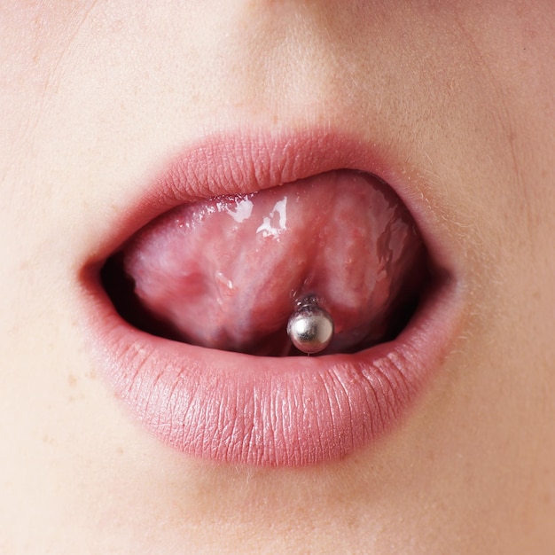 A closeup shot of female tongue piercing