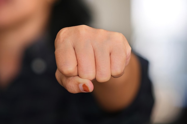 Closeup shot of females hand hand fist with blurry background