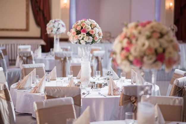 Closeup shot of a flower bouquet in a vase on a table at a wedding hall