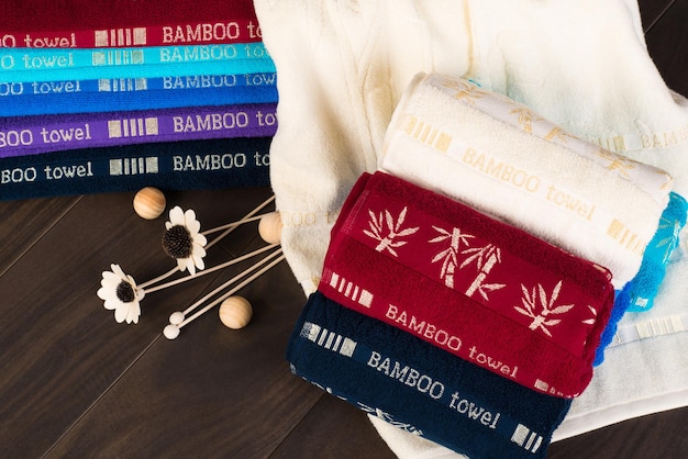 A closeup shot of folded colorful bamboo towels on a bathroom floor