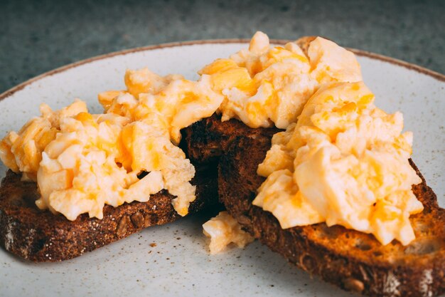 Closeup shot of a gourmet scrambled egg sandwich on a plate