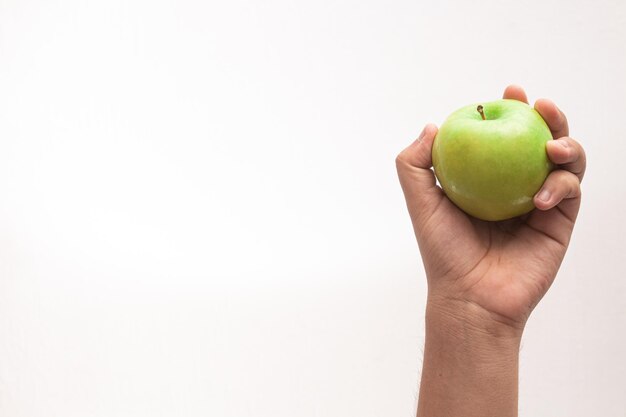 Closeup shot of a green apple on hand