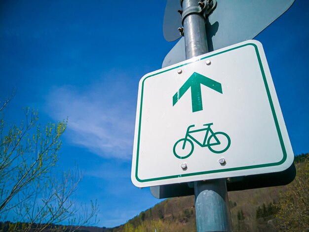 Photo closeup shot of green signage for bicycle direction indication