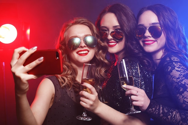 Closeup shot of group of laughing girls having party take self