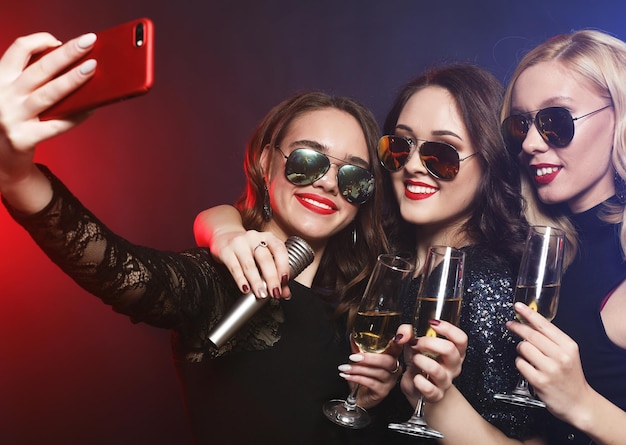 Closeup shot of group of laughing girls having party take self