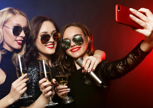 Closeup shot of group of laughing girls having party take self