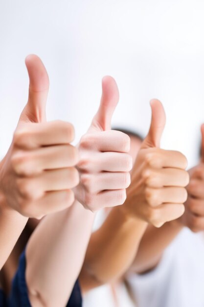 Photo closeup shot of a group of unrecognizable people showing thumbs up created with generative ai