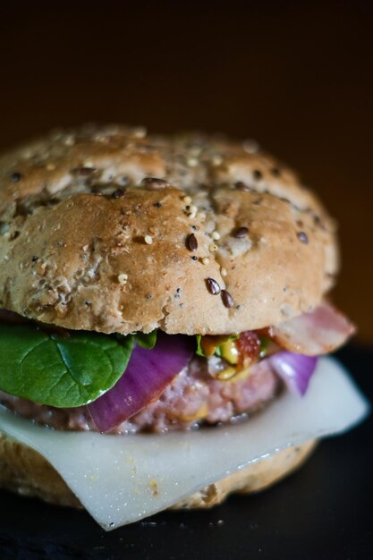 Photo closeup shot of a handmade hamburger on a slate board