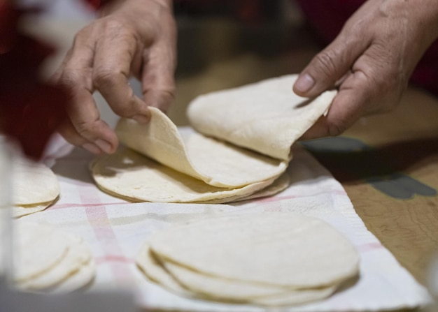 Closeup shot of hands sorting through tortillas