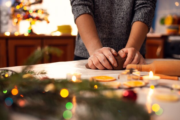 Closeup shot of hands of a young girl making dough