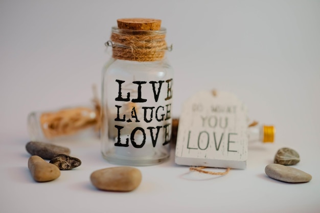 Closeup shot of a jar with the text live laugh love in a decoration set