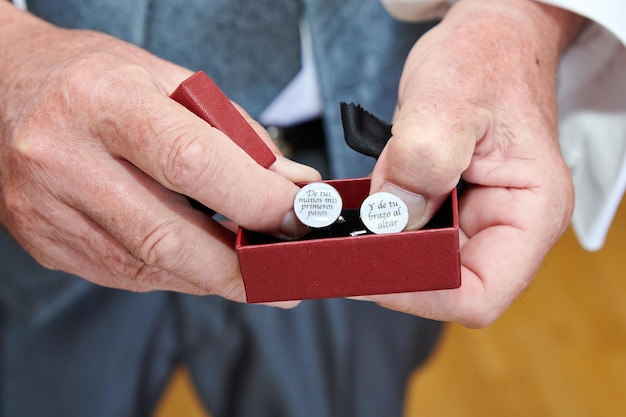 Closeup shot of male hands holding a box of earrings