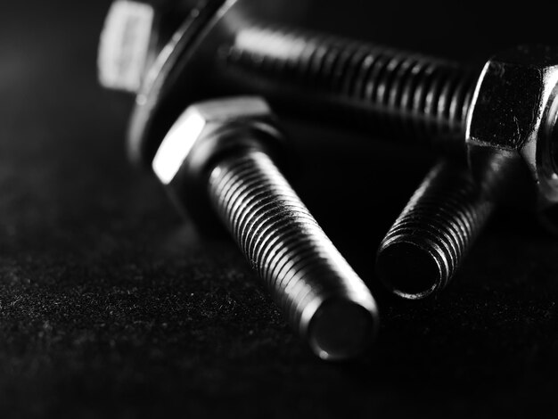 Closeup shot of metal screw threads isolated on the black background