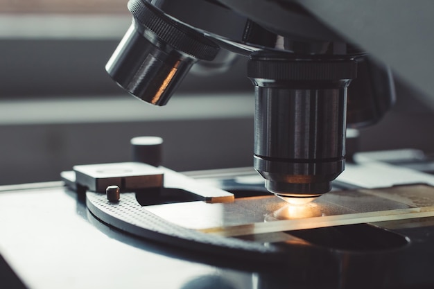 Closeup shot of microscope with metal lens at laboratory