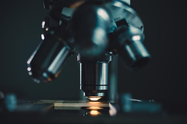 Closeup shot of microscope with metal lens at laboratory