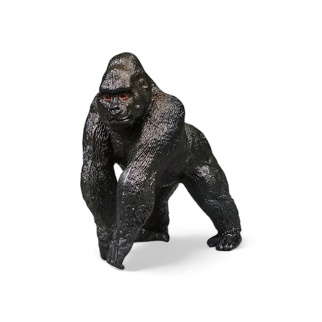 closeup shot of a miniature toy gorilla animal on a white background