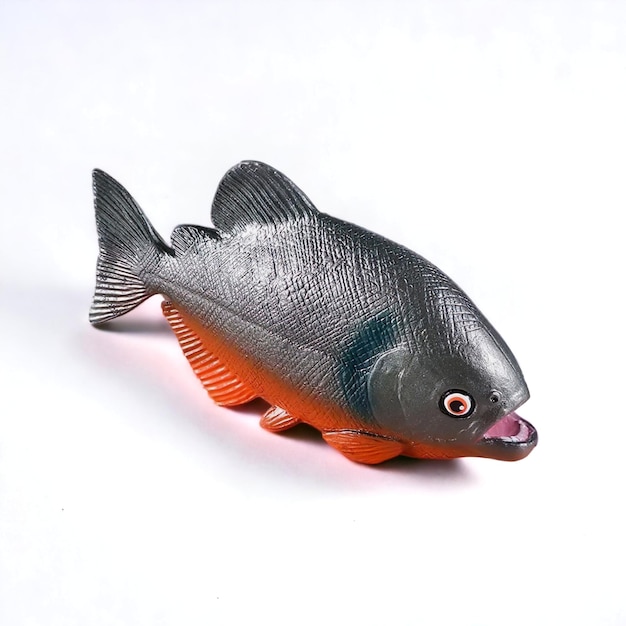 Closeup shot of a miniature toy piranha fish side view against a white background